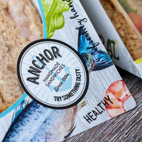 close up of sandwich packaging to show detailed illustrations and logo.